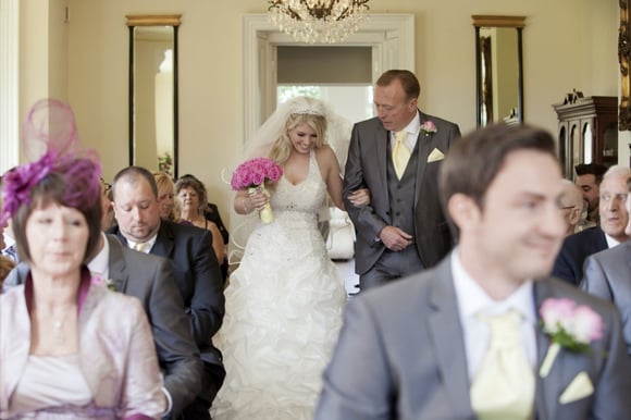 bride and brides father walking down the aisle