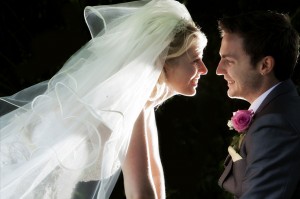 The wedding day kiss image of bride and groom close up kiss
